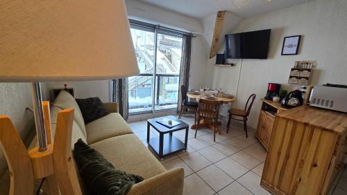 a living room with a couch and a table at Cosy'PY in Bagnères-de-Bigorre