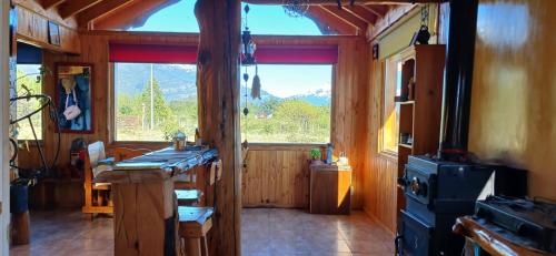 a kitchen with a stove and a large window at Los Trevelinos in Trevelin