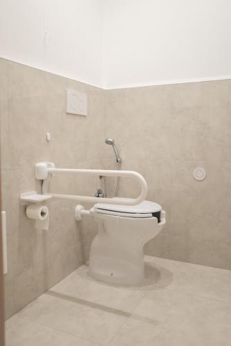 a bathroom with a white toilet in a room at Geranium B&B in Bitonto