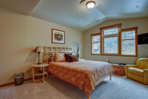 a bedroom with a bed and a chair at Three Rivers 30 day minimum in Hood River