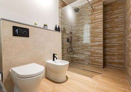 a bathroom with a toilet and a shower at La Fortezza Exclusive - Spazio e Relax in Centro in Livorno
