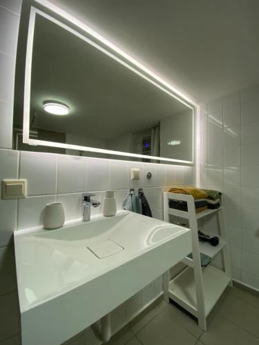 a bathroom with a white sink and a mirror at Ferienhaus "Sofia" Anno 1650, NEU - Top Lage - Tempur Beds - WIFI - Parking - im Herzen von Detmold-Altstadt, Historische Stadtmauer, Old lane Detmold in Detmold