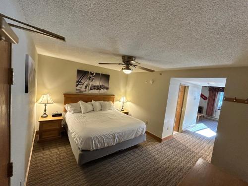 a bedroom with a bed and a ceiling fan at Grand Lodge Crested Butte in Crested Butte