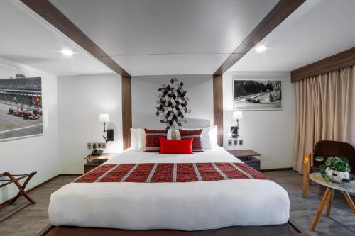 a bedroom with a large white bed with red pillows at Flow Condesa - Adults Only in Mexico City