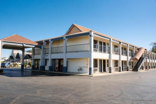 an empty parking lot in front of a building at Days Inn by Wyndham Monroe, Louisiana in Monroe