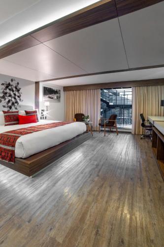 a bedroom with a large bed and a desk at Flow Condesa - Adults Only in Mexico City