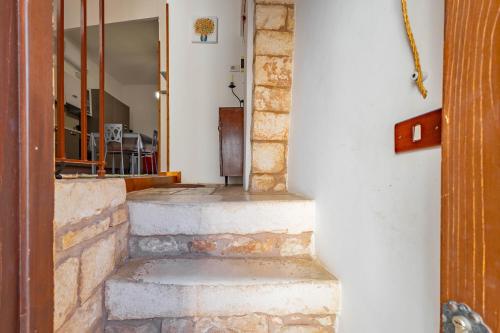 a set of stone stairs leading to a house at Antiche Mura Apartments "Nel Cuore della Puglia"bivani, cucina, terrazzo in Turi