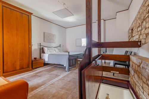 a living room with a bed and a room with at Antiche Mura Apartments "Nel Cuore della Puglia"bivani, cucina, terrazzo in Turi