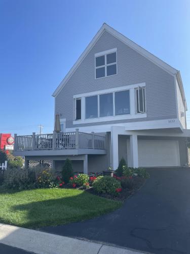 a large house with a porch and a balcony at Papa & Gigi's Lake Front Home in Port Clinton
