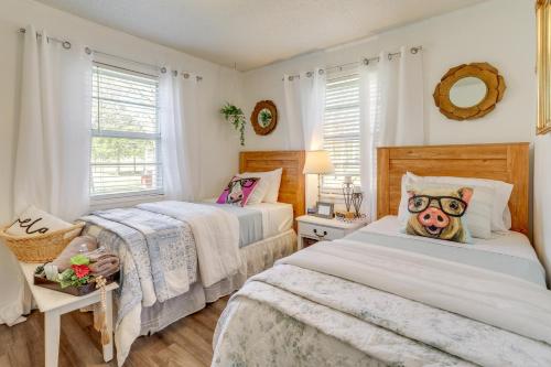 a bedroom with two beds and a large window at Nature Lovers Haven with Fire Pit in Pangburn! in Pangburn