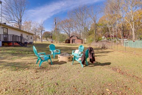 a group of chairs sitting in a yard at Nature Lovers Haven with Fire Pit in Pangburn! in Pangburn