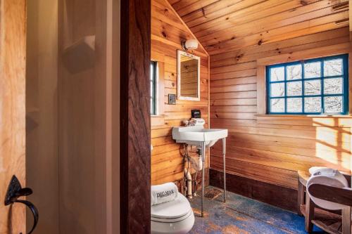 a bathroom with a toilet and a sink at Large waterfront home with direct beach access in Dennis