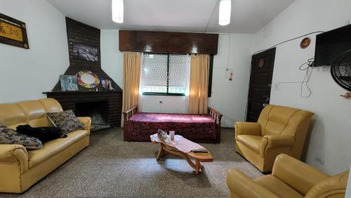 a living room with two couches and a coffee table at Casa Cedro Azul II in Villa Carlos Paz