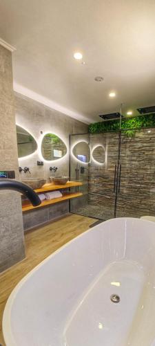 a bathroom with a large white tub in a room at The View House in Albufeira