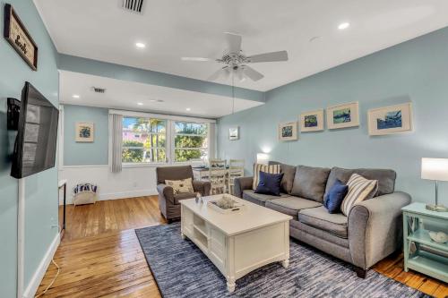 a living room with a couch and a table at Slo M'Ocean in Anna Maria
