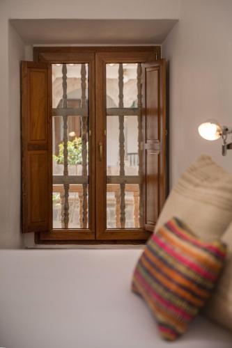 a close up of a window with a pillow in front of it at Casa Clara by Ananay Hotels in Cusco