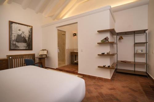 a bedroom with a white bed and a staircase at Casa Clara by Ananay Hotels in Cusco