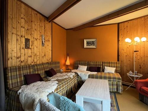 a hotel room with two beds and a table at Résidence Bero Bisto - maeva Home - Studio 4 personnes - Confort MAE-1951 in La Mongie