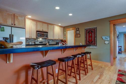 a kitchen with a counter with bar stools at Wanderlust in Hood River
