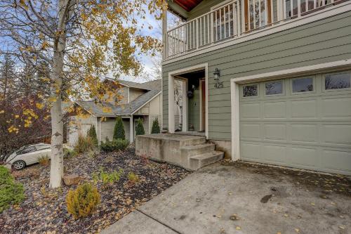 a house with a white garage door and a car at Wanderlust in Hood River