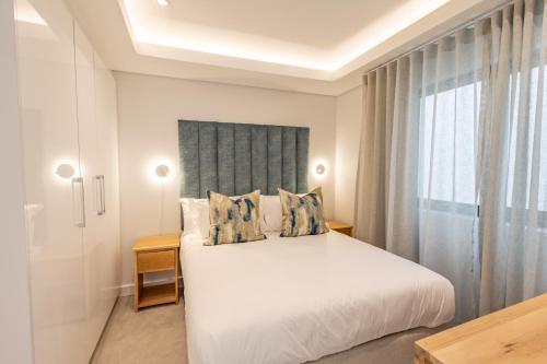 Ένα ή περισσότερα κρεβάτια σε δωμάτιο στο Plett Quarter Apartments