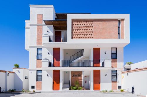 a large white building with a staircase on it at Josefa Suites in La Paz