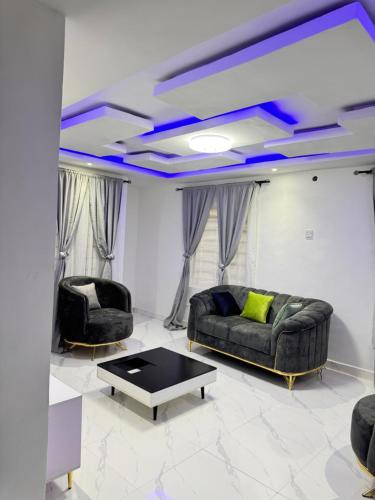 a living room with a couch and a table at Sunny Service Apartment in Lagos