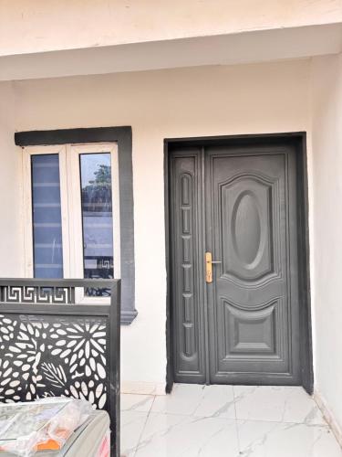 a gray door on the side of a house at Sunny Service Apartment in Lagos