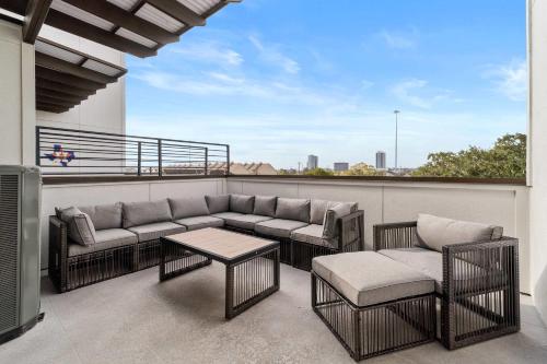 a balcony with a couch and chairs and a table at Spacious Houston 3Bed3 Bath Family Townhome in Houston