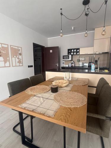 a wooden table with two chairs and a kitchen at The Tower - Lovely apartment @ Bansko Royal Towers in Bansko