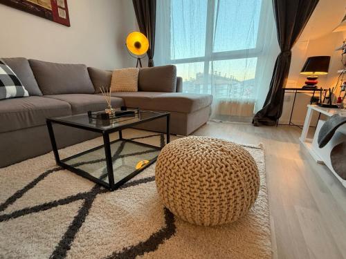 a living room with a couch and a coffee table at The Tower - Lovely apartment @ Bansko Royal Towers in Bansko
