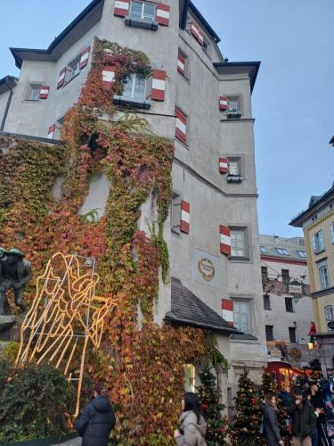 a building covered in ivy in front of a building at Aktiv Hotel Zur Rose am Brenner in Steinach am Brenner