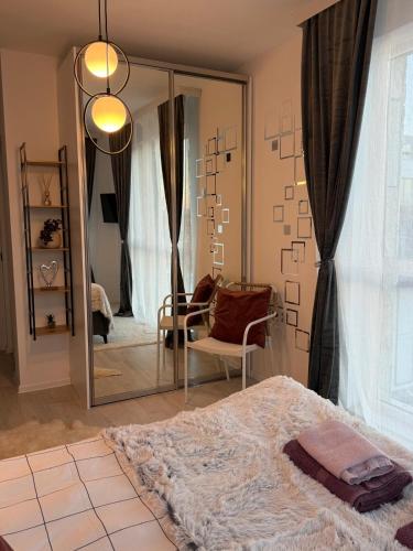 a bedroom with a mirror and a bed and a chair at The Tower - Lovely apartment @ Bansko Royal Towers in Bansko