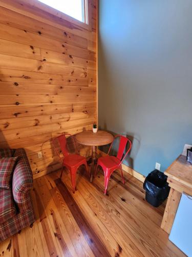 a room with a table and two red chairs at Lodge At Tellico in Tellico Plains