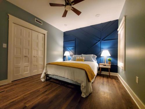 a blue bedroom with a bed with a ceiling fan at Pickwick Places 202 in Springfield