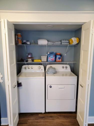 a small kitchen with two washes and shelves at Pickwick Places 202 in Springfield
