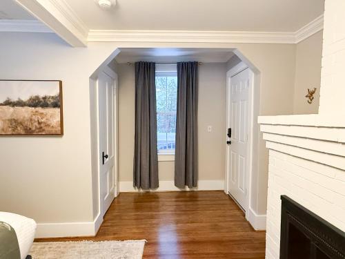 a living room with a fireplace and a window at The Aurora Inn & Cottages in Bartlett