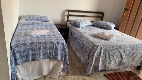 Ένα ή περισσότερα κρεβάτια σε δωμάτιο στο Hospedagem Familiar Cantinho Para-ti