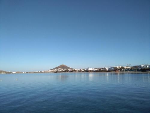 a large body of water with a mountain in the background at Theofanis Studios in Agia Anna Naxos