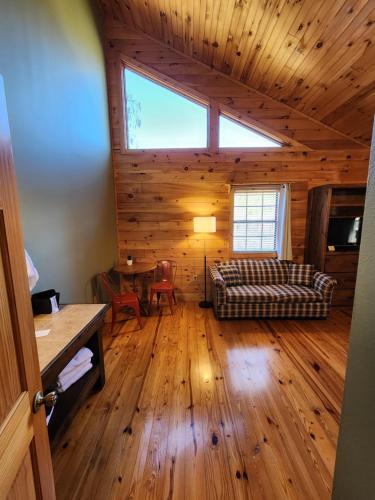 a living room with a couch and a table at Lodge At Tellico in Tellico Plains
