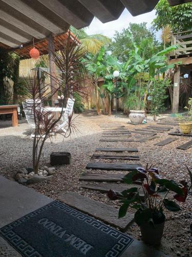 a garden with a pathway with trees and plants at Pousada Recanto dos Pássaros in Peruíbe