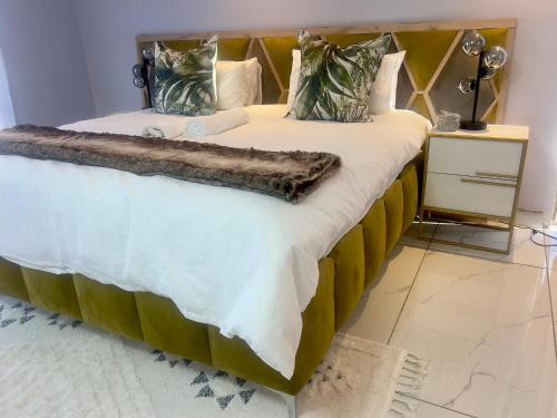 a bedroom with a large bed with a wooden headboard at Grace Boutique Guest House in Manamakgoteng
