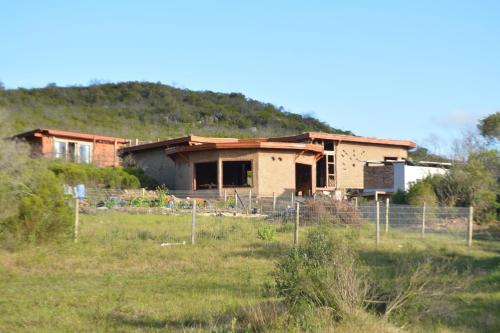 a house that is being built in a field at Terra Cristal - Amatista in Piriápolis