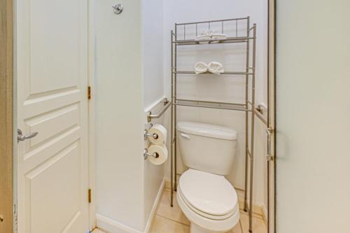 a bathroom with a toilet with a metal rack at 26 Mi to Fresno Pet-Friendly Home in Reedley! in Reedley