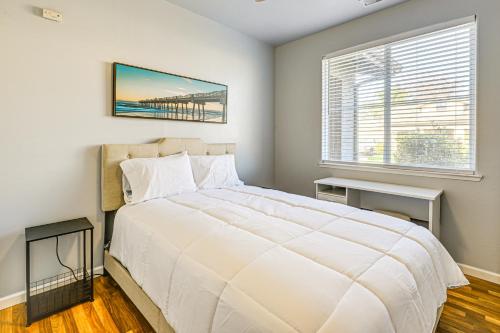 a bedroom with a large white bed and a window at 26 Mi to Fresno Pet-Friendly Home in Reedley! in Reedley