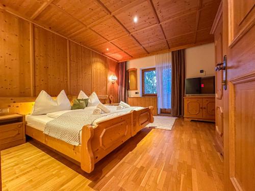 a bedroom with a large wooden bed in a room at Luna Studios Zillertal in Hippach
