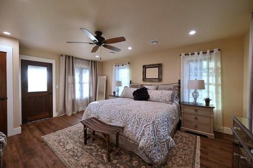 a bedroom with a bed with a cat sitting on it at Gateway Gathering - House in Luckenbach