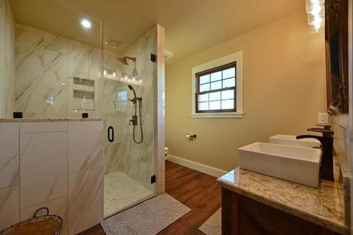 a large bathroom with a shower and a sink at Gateway Gathering - House in Luckenbach