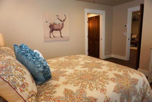 a bedroom with a bed with a deer on the wall at Gateway Gathering - House in Luckenbach