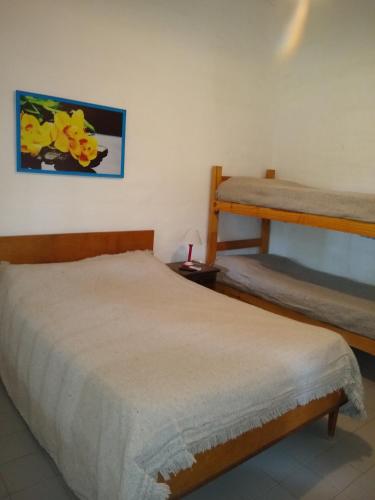 a bedroom with two bunk beds in a room at Complejo Viejo Sulky in Mina Clavero